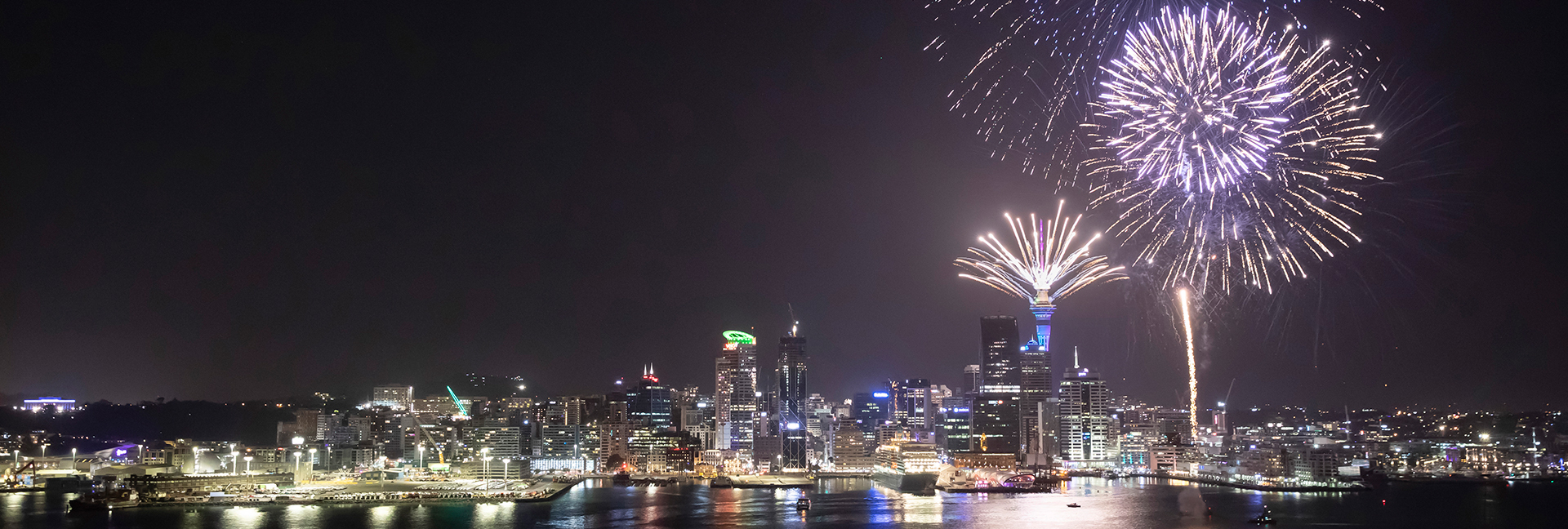 Auckland Harbour at midnight New Year's Eve with Port of Auckland to the right, Heart of the City in the middle and fireworks to the right of image