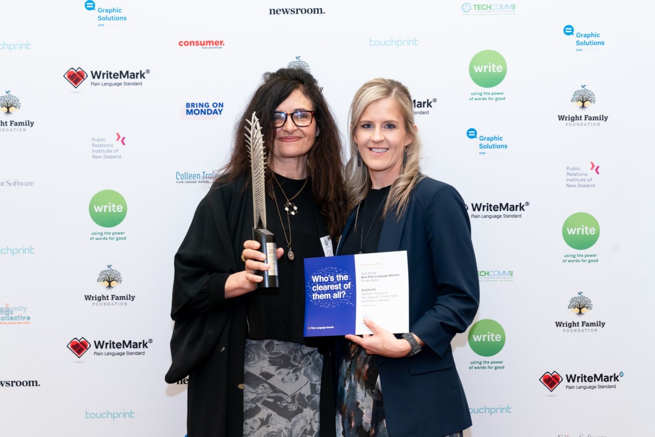 KidsHealth staff holding the 2025 Plain language awards trophy
